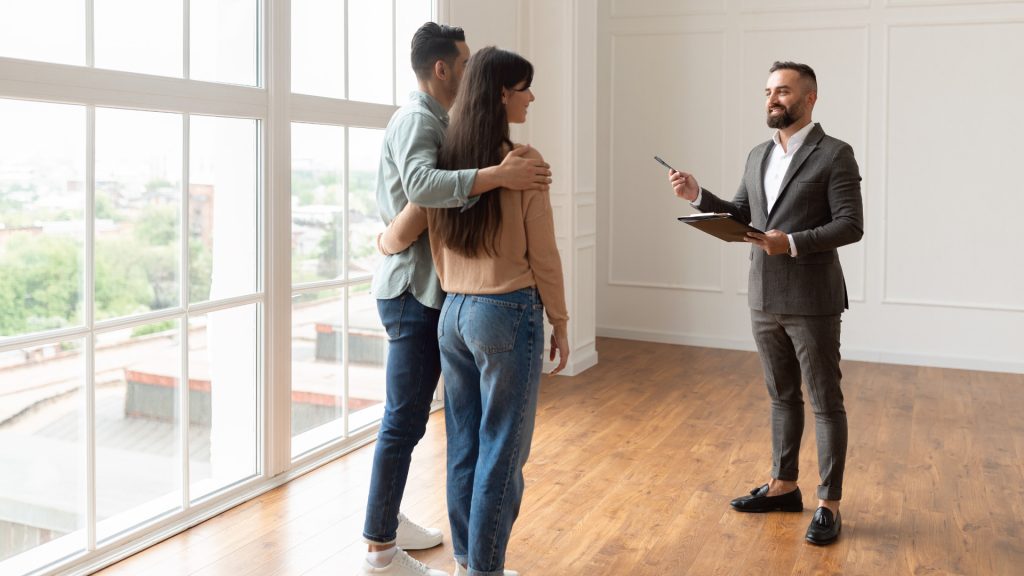 A landlord greets his tenant for an inspection of their new apartment